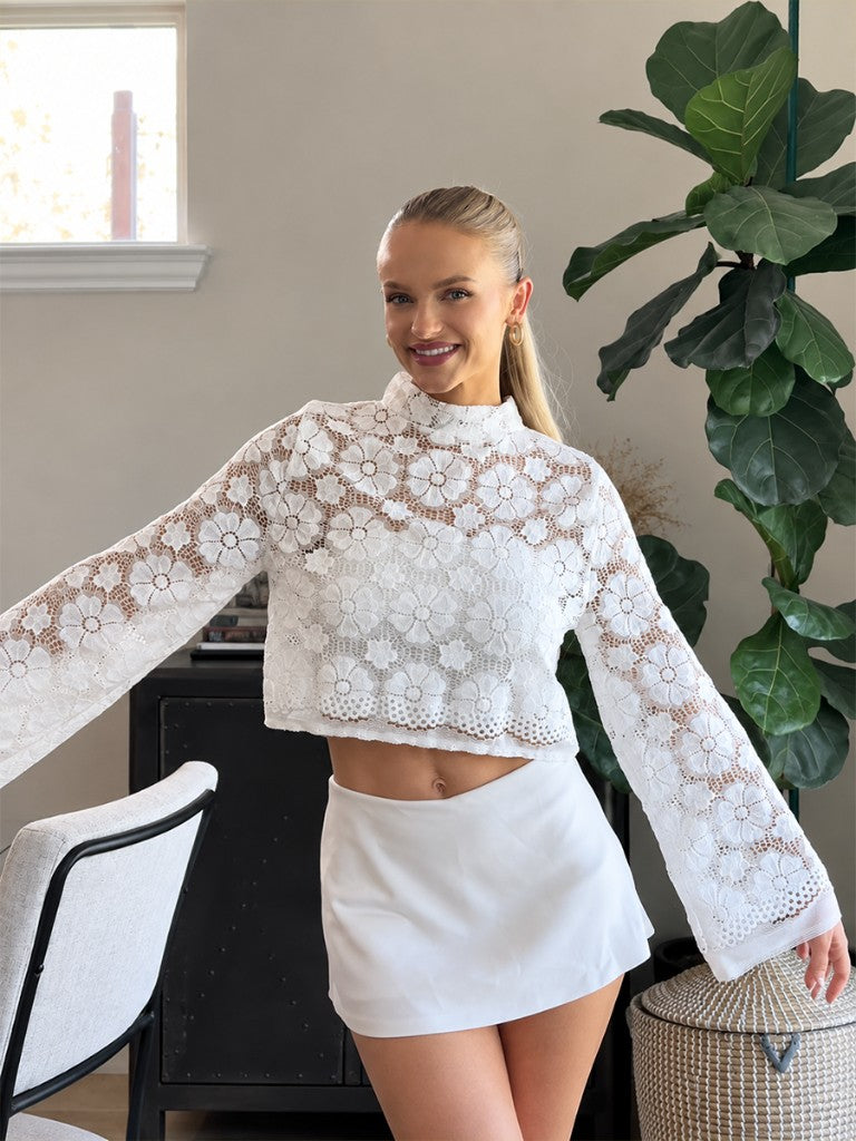 A sewn ALTR HOUSE cropped turtleneck t-shirt with moderate bell sleeves and a straight hem