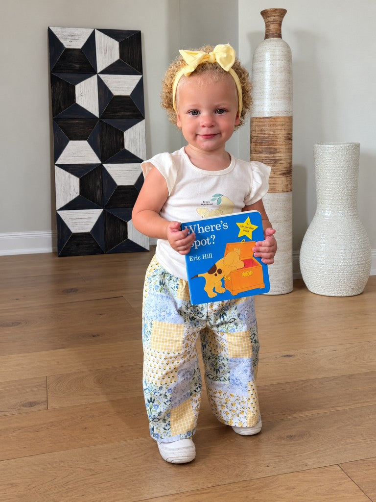 A child wearing patchwork pants sewn from a custom baby pants sewing pattern